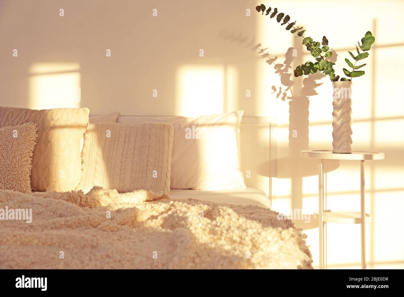 White interior of modern bedroom with cozy double bed Stock Photo - Alamy
