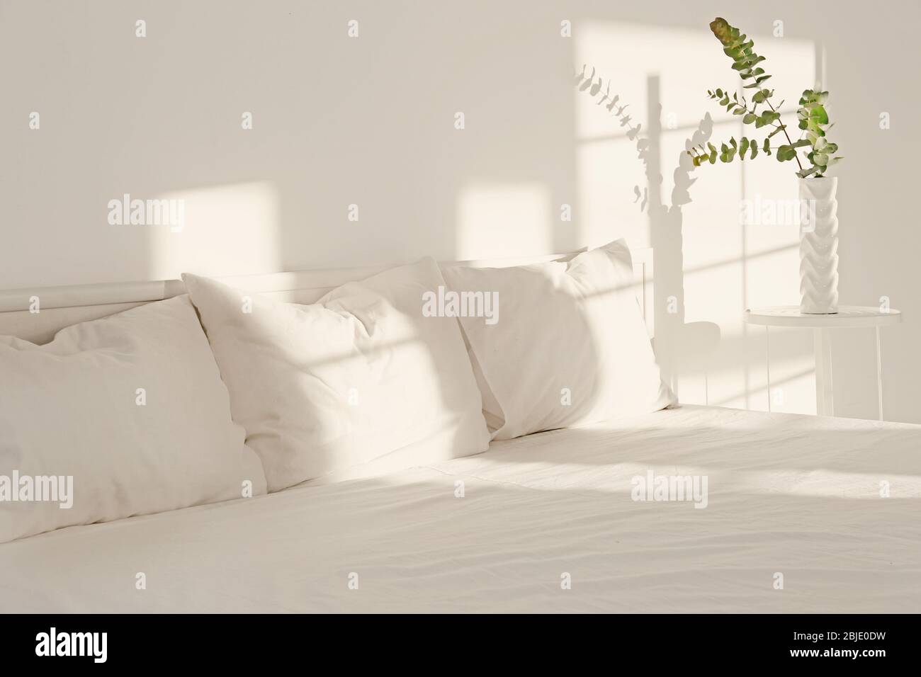 White interior of modern bedroom with cozy double bed Stock Photo - Alamy
