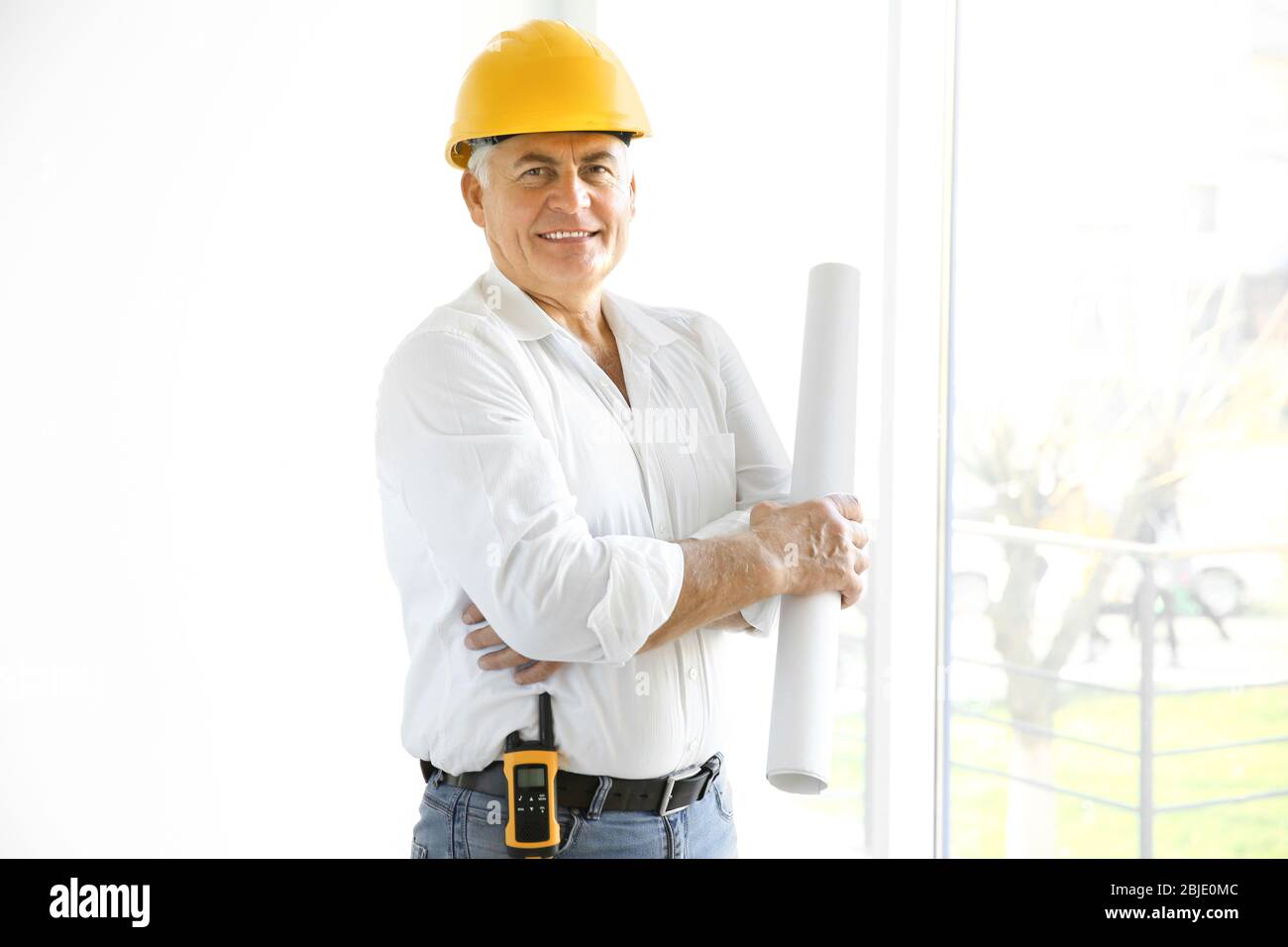 Senior engineer standing inside new building Stock Photo