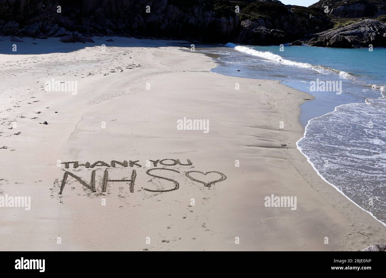 Thank you NHS tribute, in the sand, to the National Health Service staff during the Coronavirus pandemic from people living on the Scottish islands Stock Photo