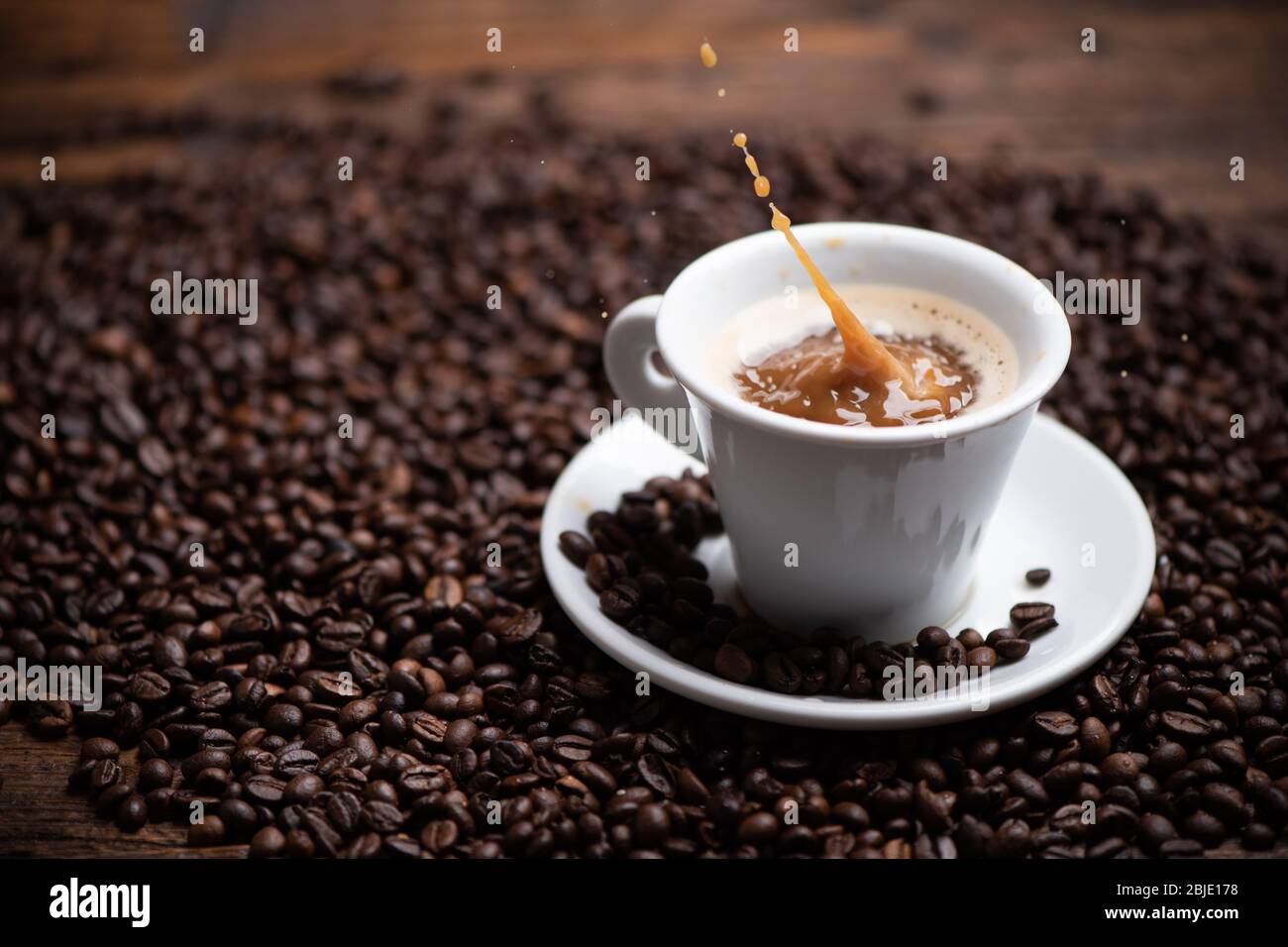 Drops of coffee splashing in a coffe milk, high speed close up Stock Photo