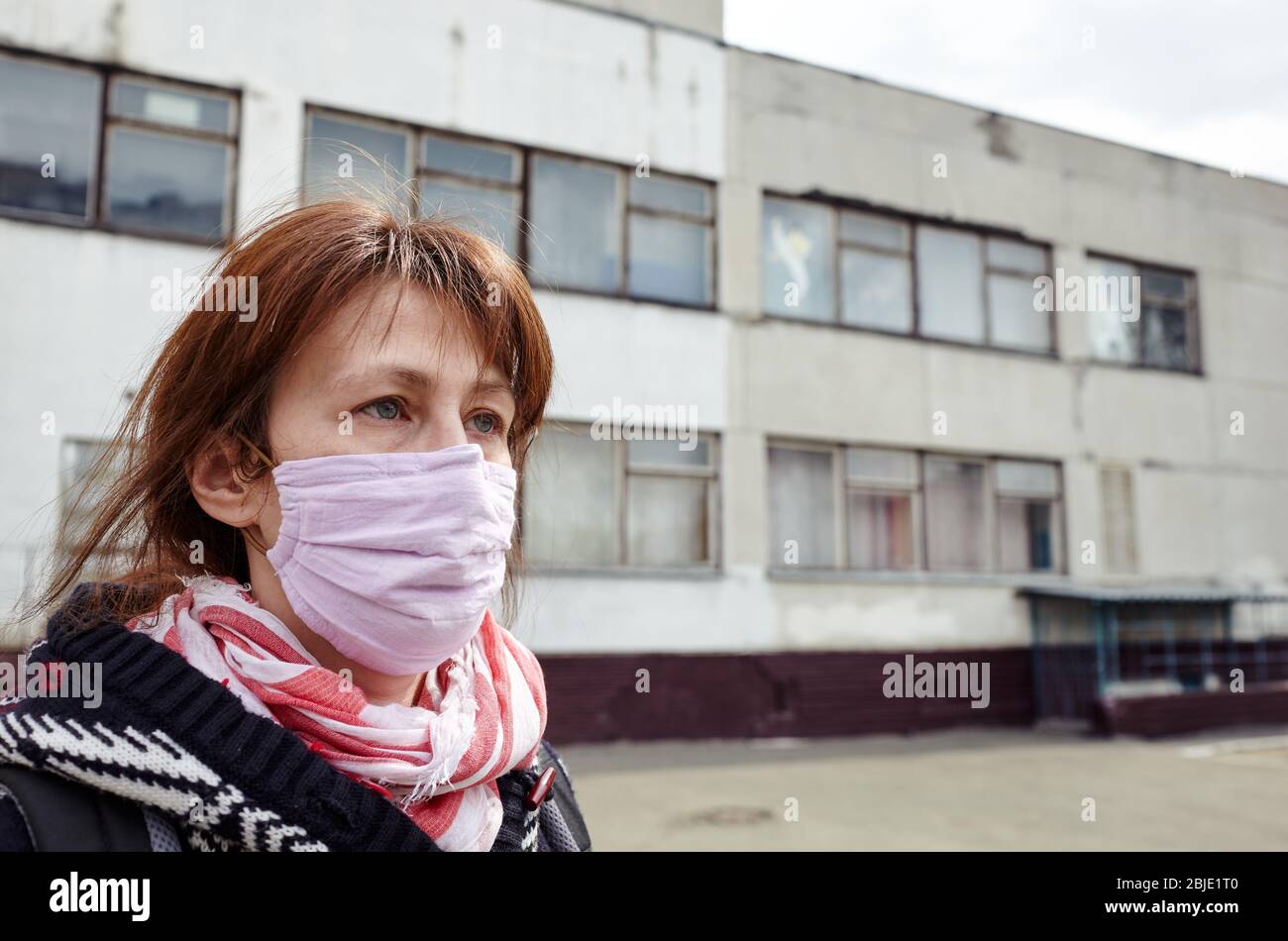 Woman wearing hygienic mask to prevent the Coronavirus. People in masks The outbreak of Novel Corona virus (2019-nCoV) in Europe. Stock Photo