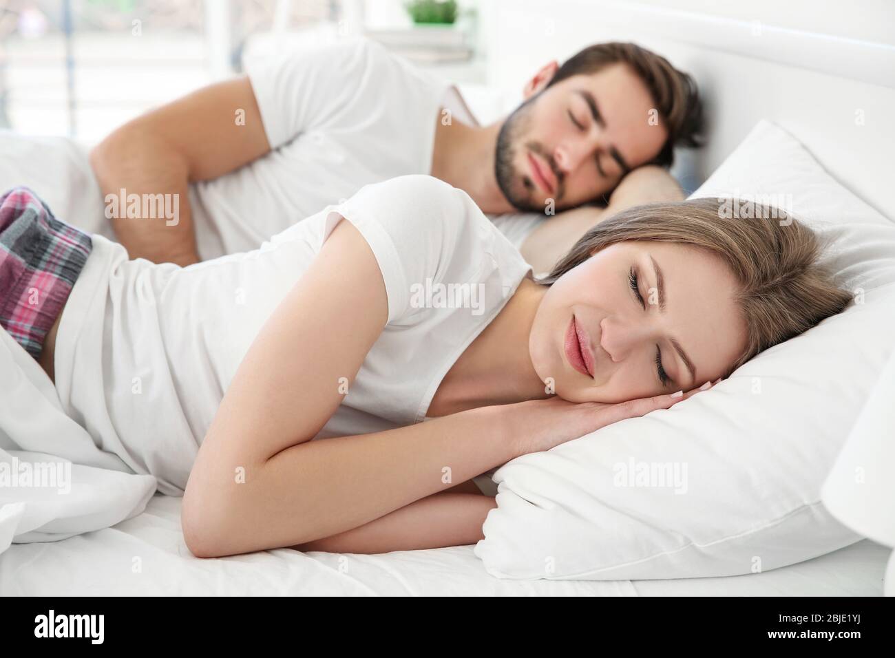 Young Cute Couple Sleeping Together In Bed Stock Photo Alamy Young Cute Couple Sleeping Together In Bed 2BJE1YJ