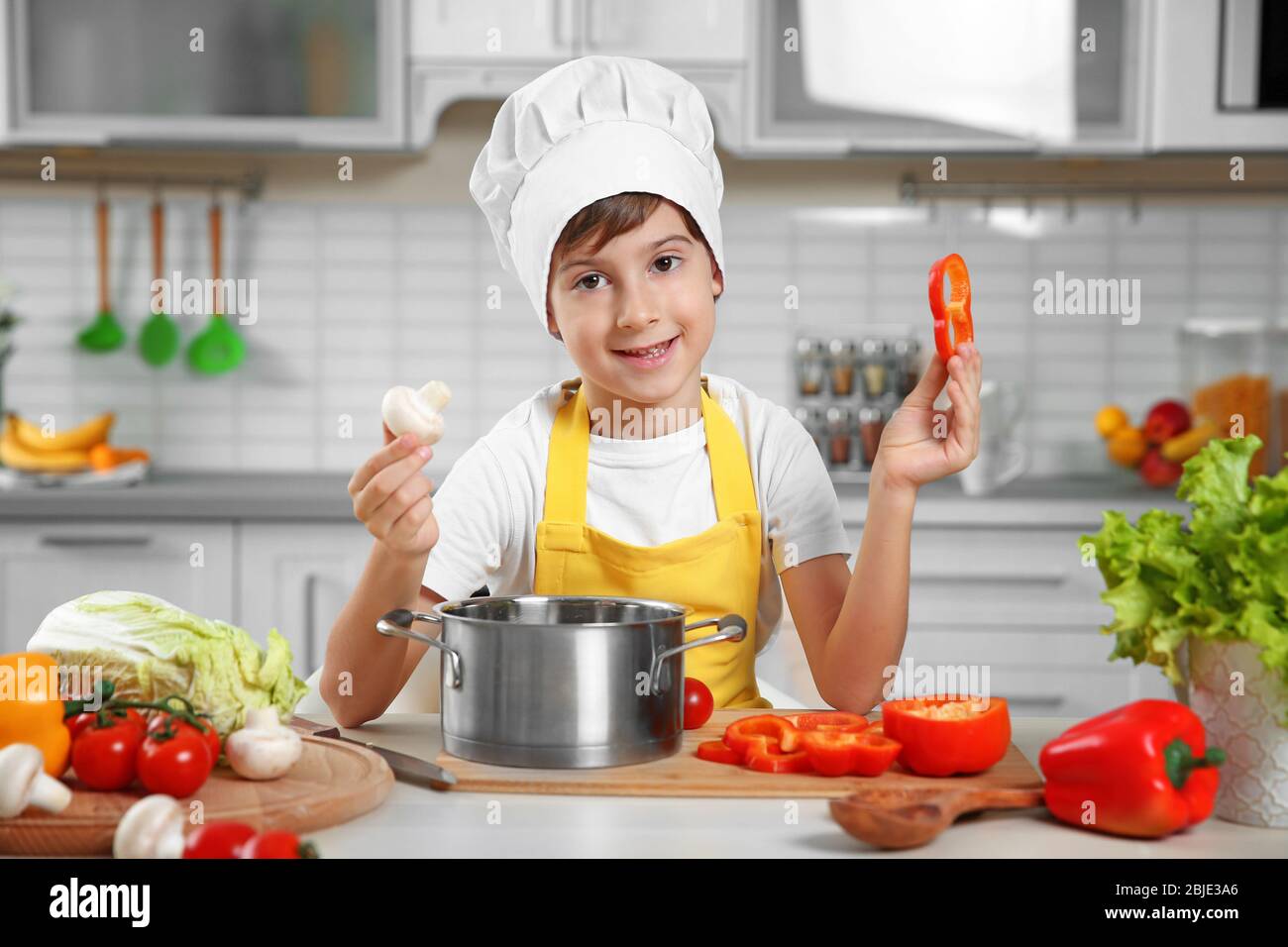 Cute Boy Cooking In Kitchen At Home Stock Photo Alamy