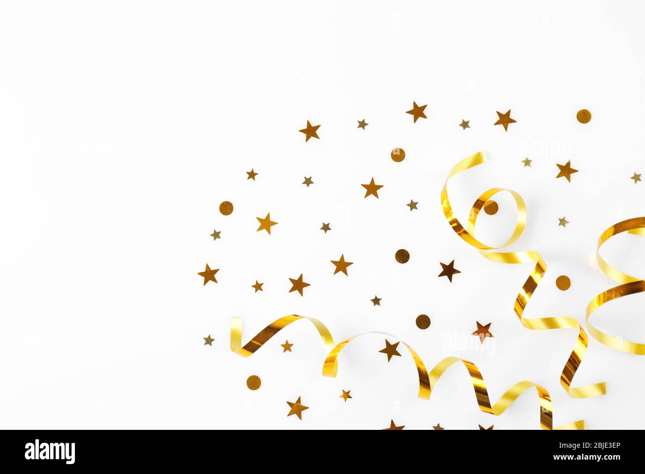 Bright confetti in shape of stars, on white background. Close up Stock Photo