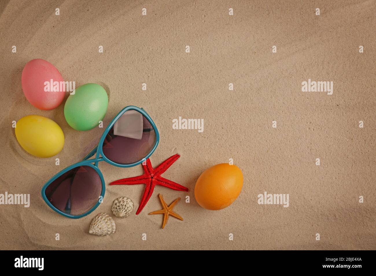 Easter eggs with shell, on sand background Stock Photo