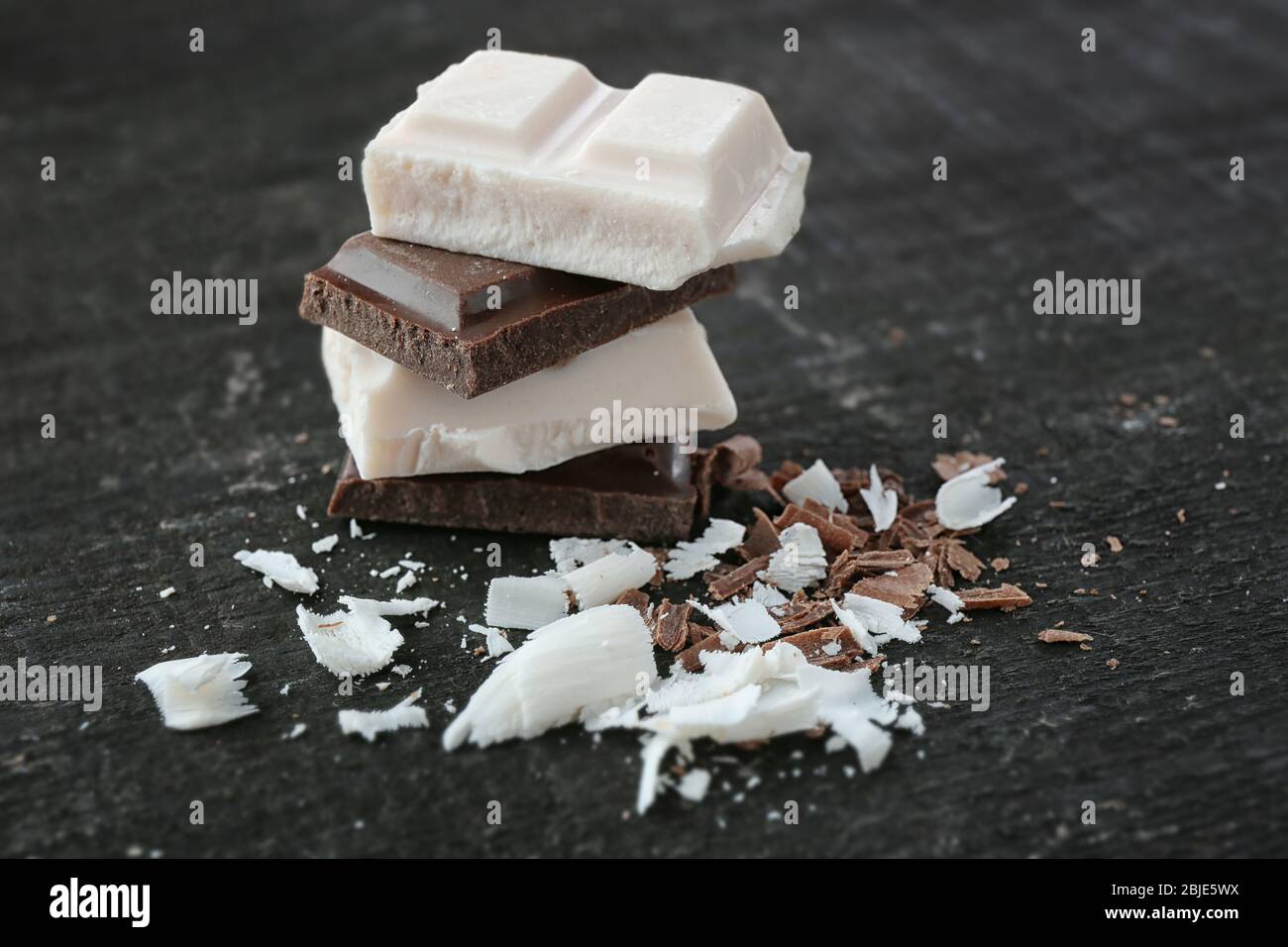 Black and white chocolate on wooden background Stock Photo - Alamy