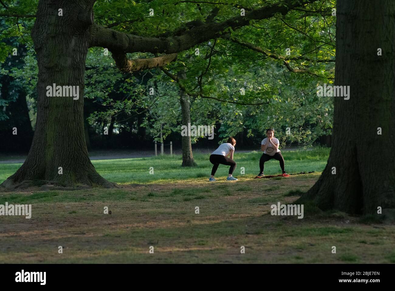 Friends exercising in Kensington Gardens in London Lockdown Stock Photo