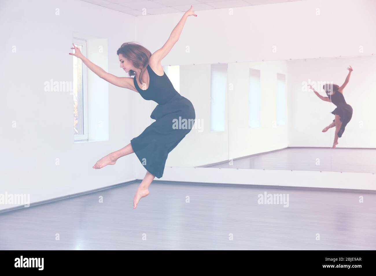 Beautiful young woman dancing in studio Stock Photo - Alamy
