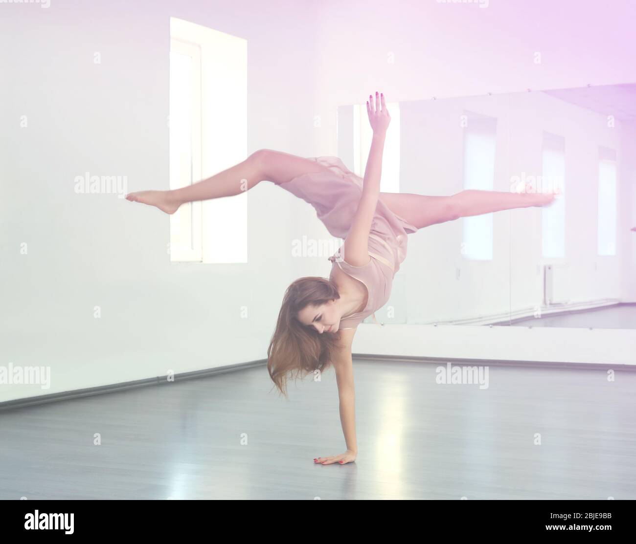 Beautiful young woman dancing in studio Stock Photo - Alamy