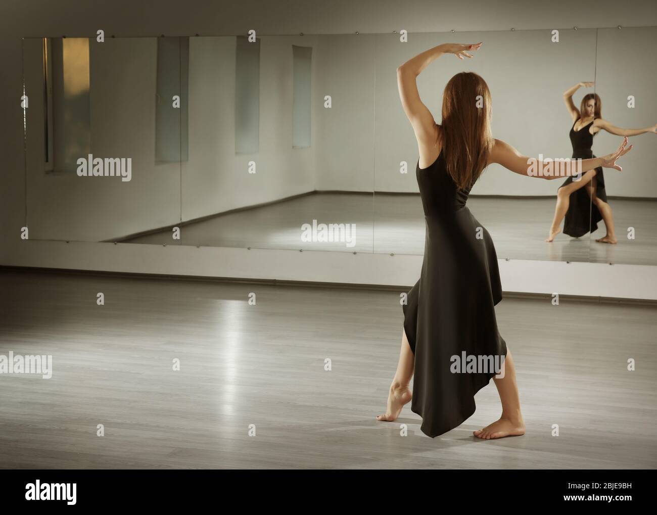 Beautiful young woman dancing in studio Stock Photo - Alamy