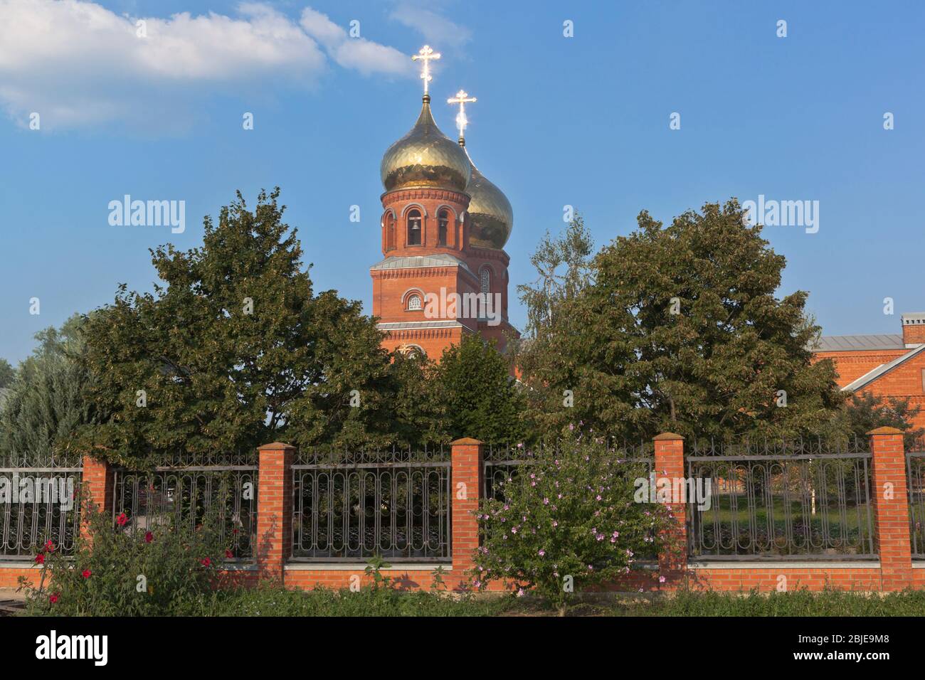 Temple of the Holy Great Martyr and Healer Panteleimon with shining crosses in the setting sun in the city of Slavyansk-on-Kuban, Krasnodar region, Ru Stock Photo