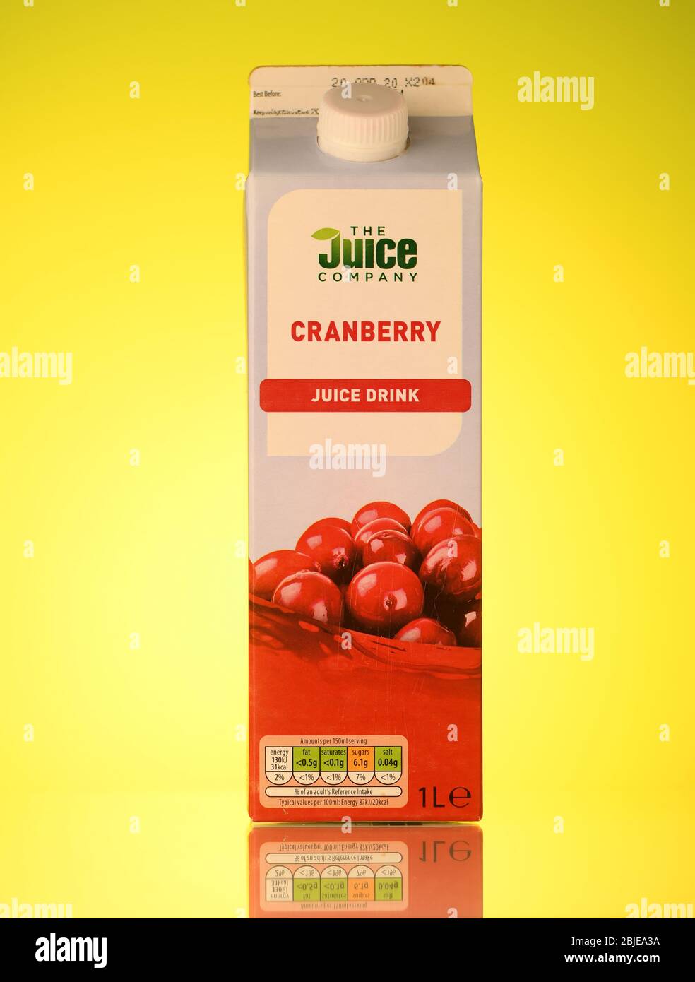 The Juice company cranberry fruit juice carton  isolated on a yellow background with a reflection. Stock Photo