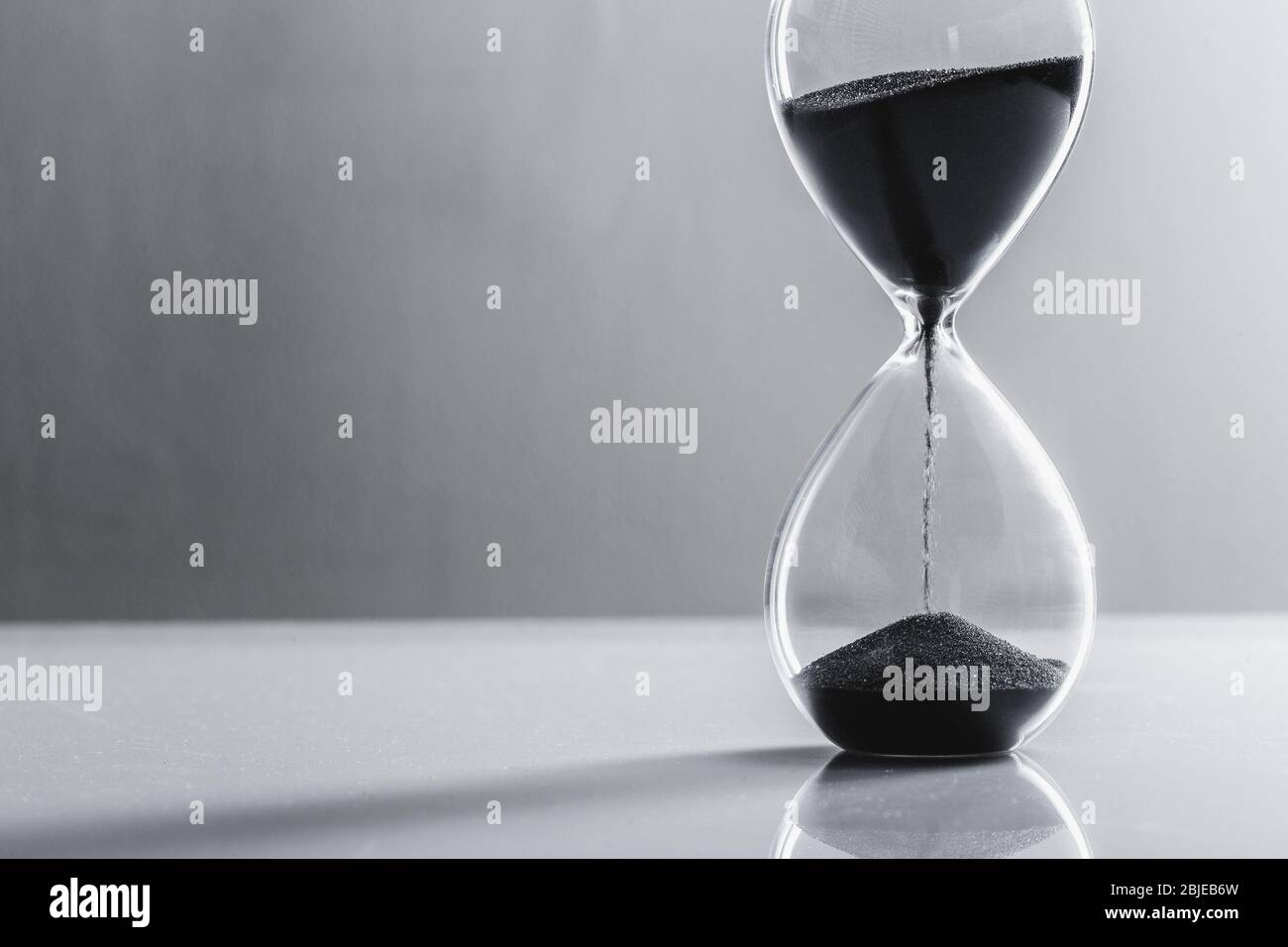 Close up hourglass on table. Close up. Stock Photo