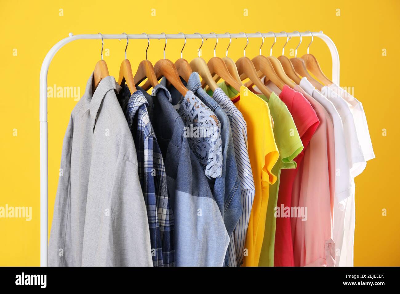 Download Hangers With Colorful Clothes On Yellow Background Stock Photo Alamy PSD Mockup Templates