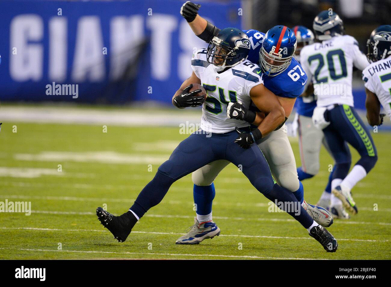 December 15, 2013: Seattle Seahawks middle linebacker Bobby Wagner (54) tries to break free from New York Giants guard Brandon Mosley (67) after a fum Stock Photo