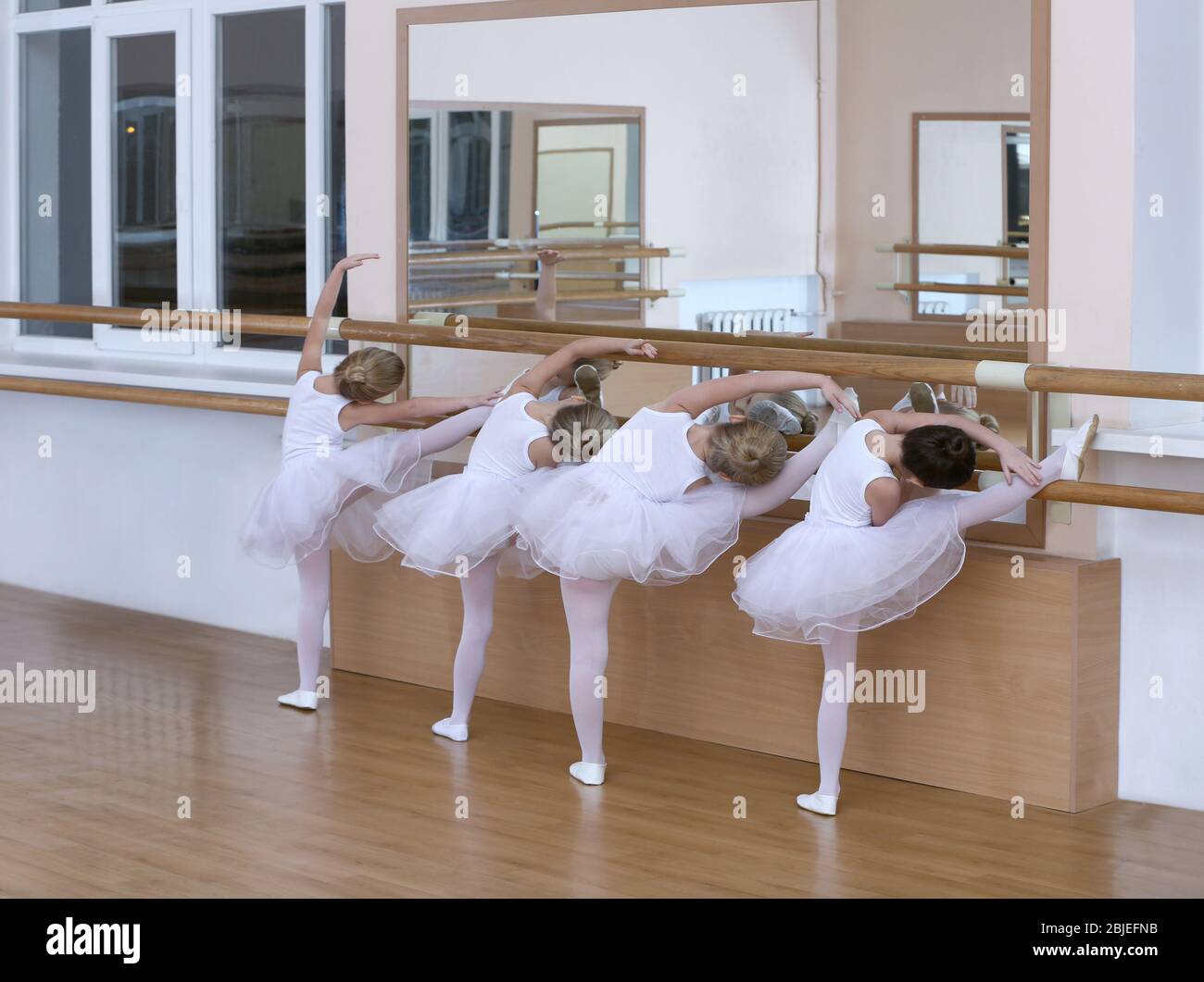 Group of little ballerinas practicing ballet using bar at class Stock Photo  - Alamy