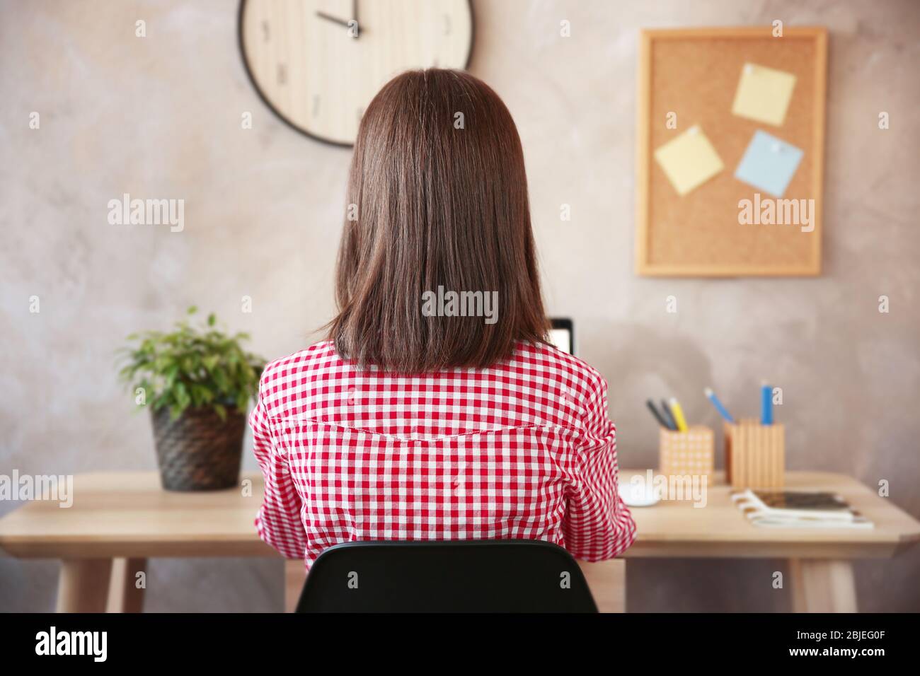 Back view woman sitting desk hi-res stock photography and images - Alamy