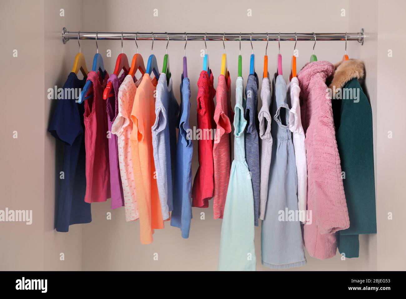 https://c8.alamy.com/comp/2BJEG53/colourful-clothes-on-hangers-in-wardrobe-2BJEG53.jpg