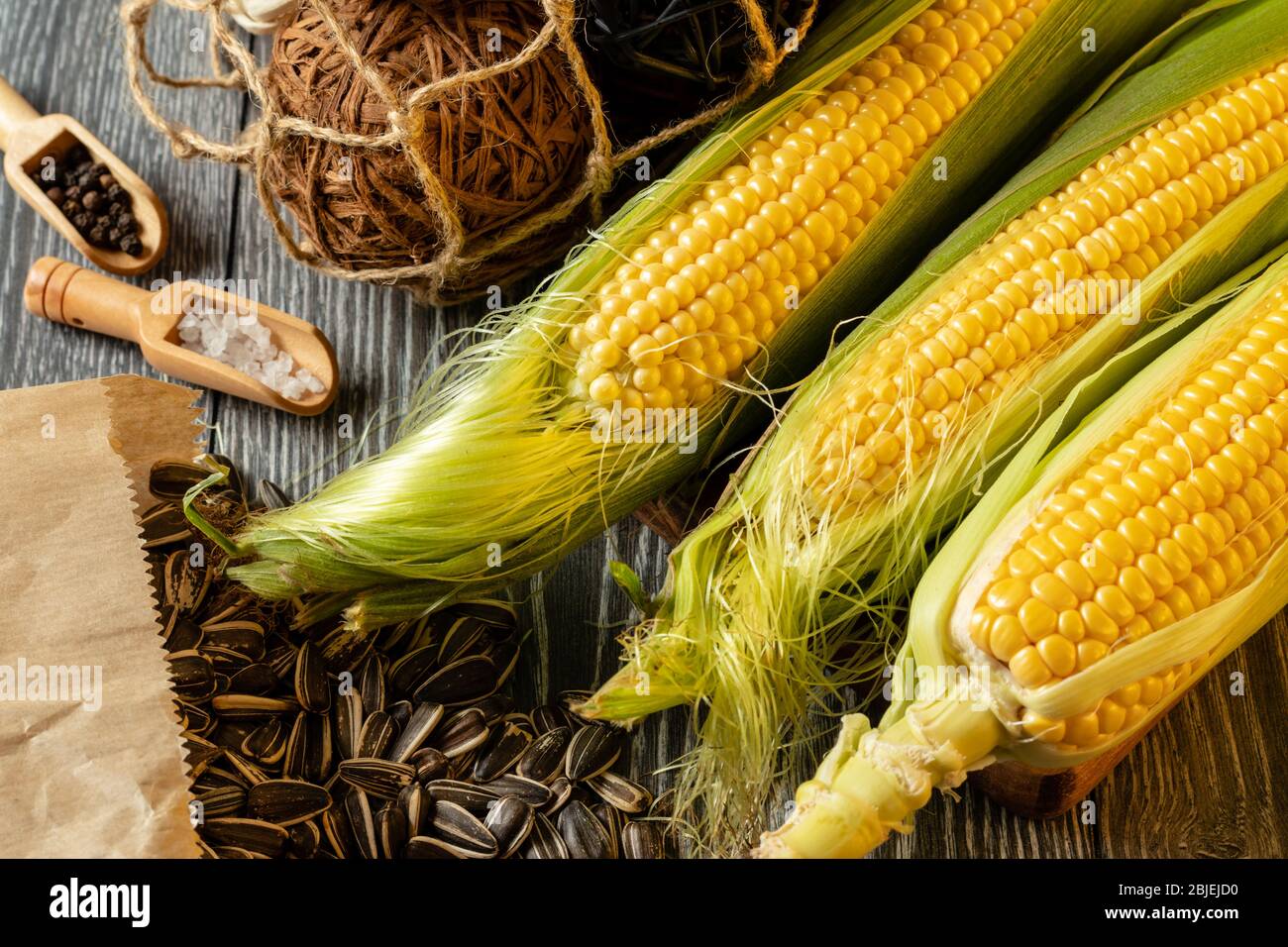 Fresh corn on cobs on rustic wooden table, closeup Stock Photo