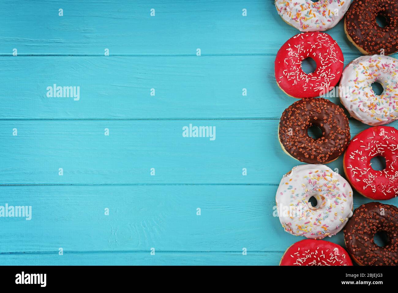 Glazed donuts on wooden background Stock Photo - Alamy