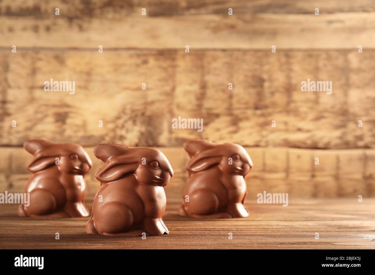 Chocolate Easter bunnies on wooden background Stock Photo