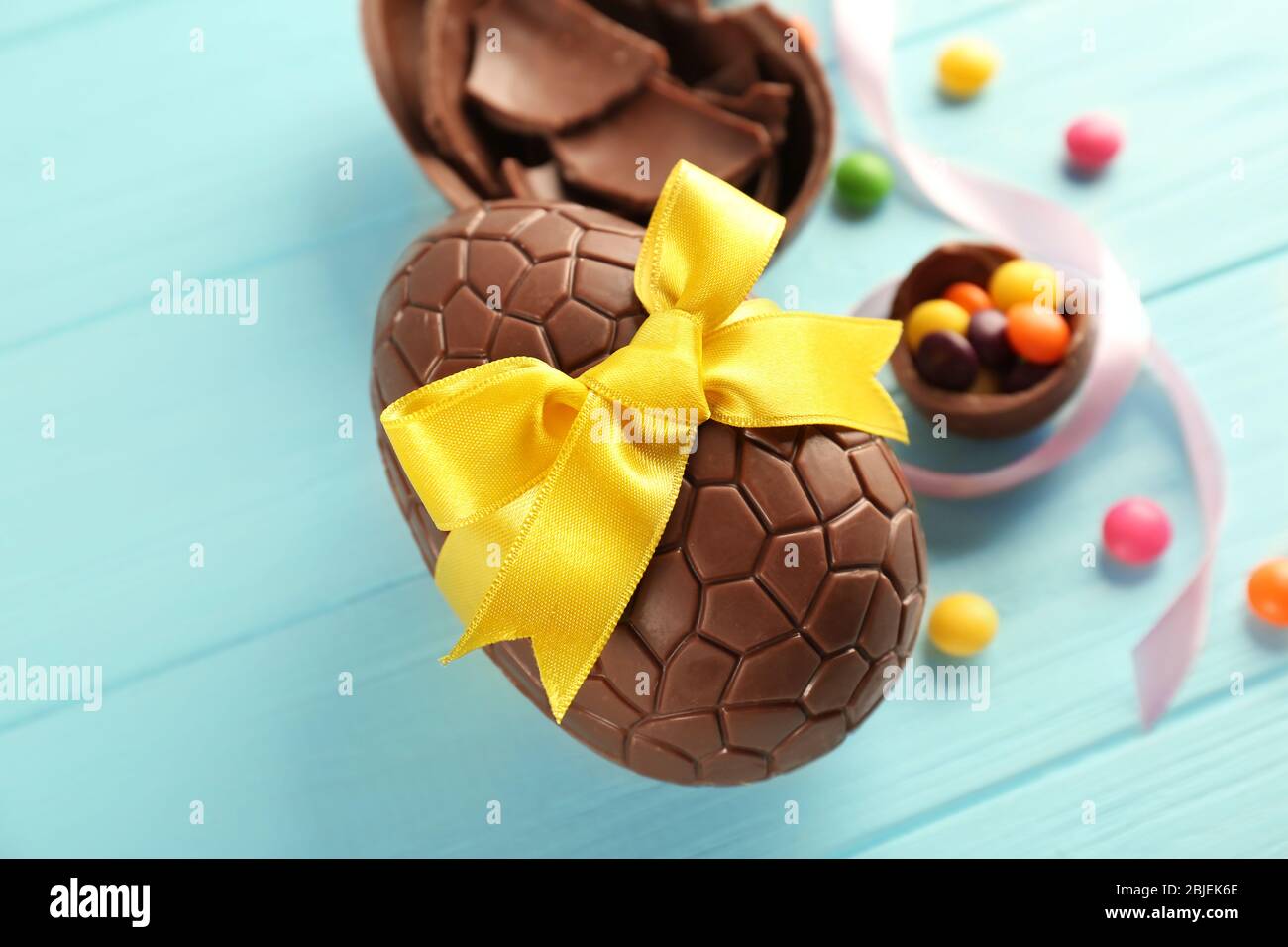 Chocolate Easter eggs on color wooden background Stock Photo