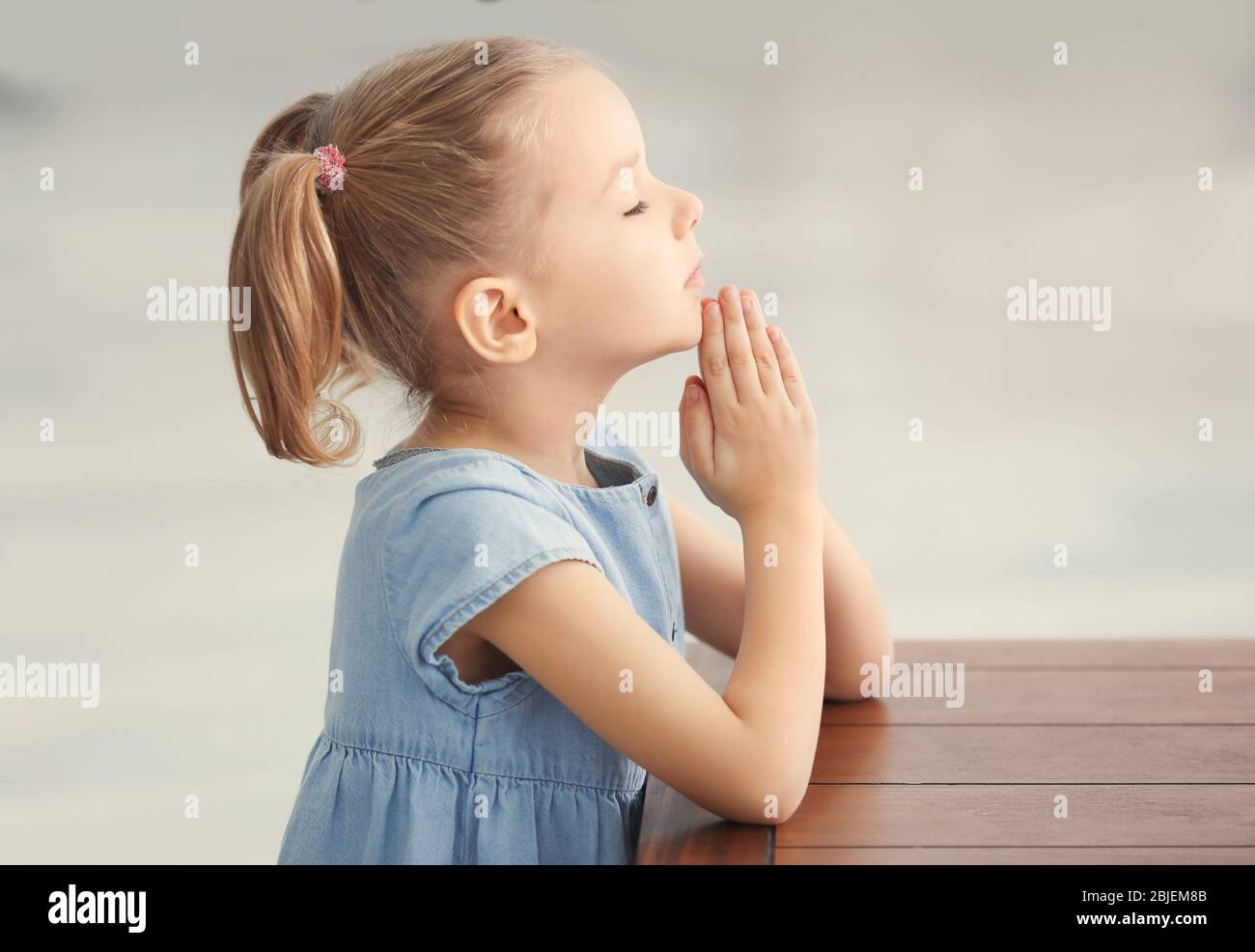 Cute little girl praying hi-res stock photography and images - Alamy