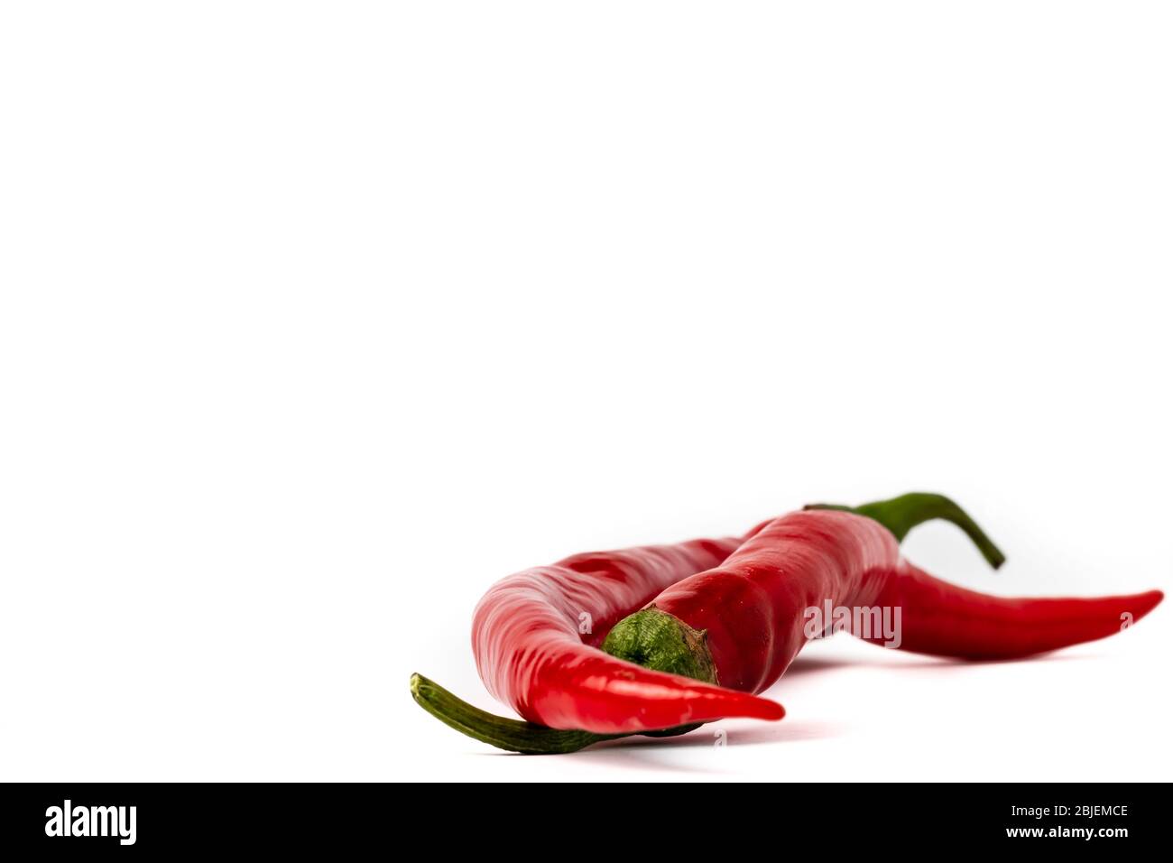 Red hot chili peppers isolated on white background Stock Photo - Alamy