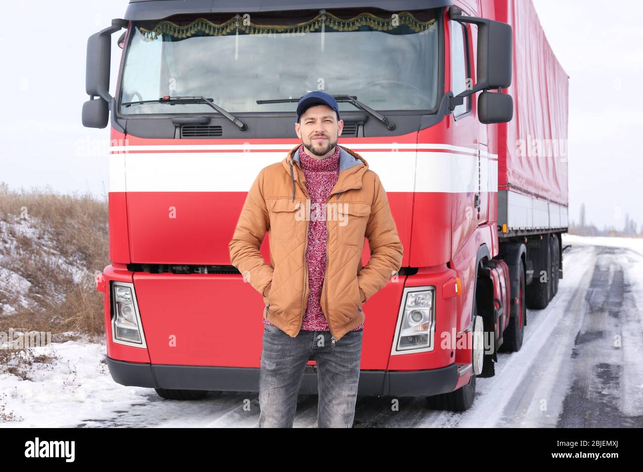 Handsome driver near big modern truck outdoors Stock Photo - Alamy