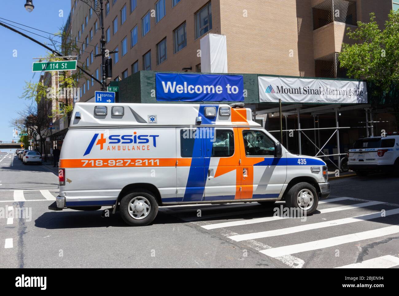 an ambulance belonging to a private emergency dispatch service called Assist Ambulance  Services standing in front of Mount Sinai Morningside Heights Stock Photo