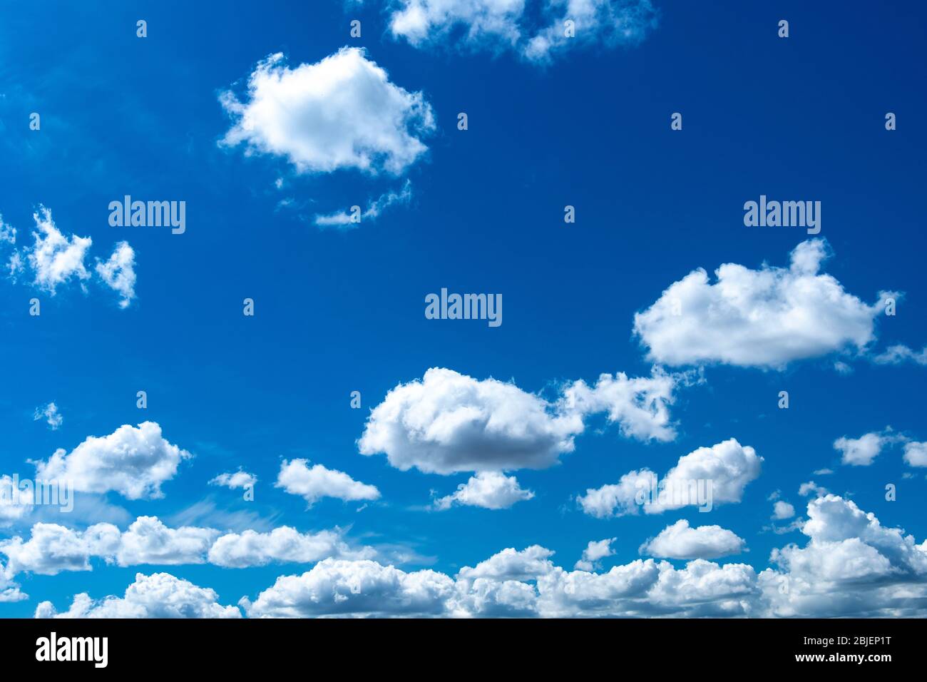 Cumulus clouds against a blue sky Stock Photo - Alamy