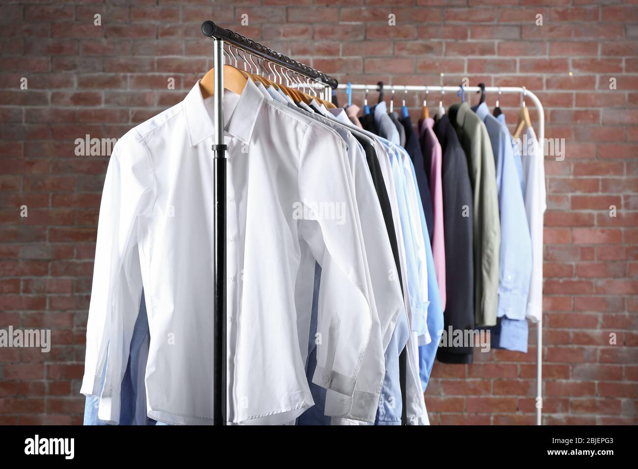 https://c8.alamy.com/comp/2BJEPG3/rack-of-clean-clothes-hanging-on-hangers-at-dry-cleaning-2BJEPG3.jpg
