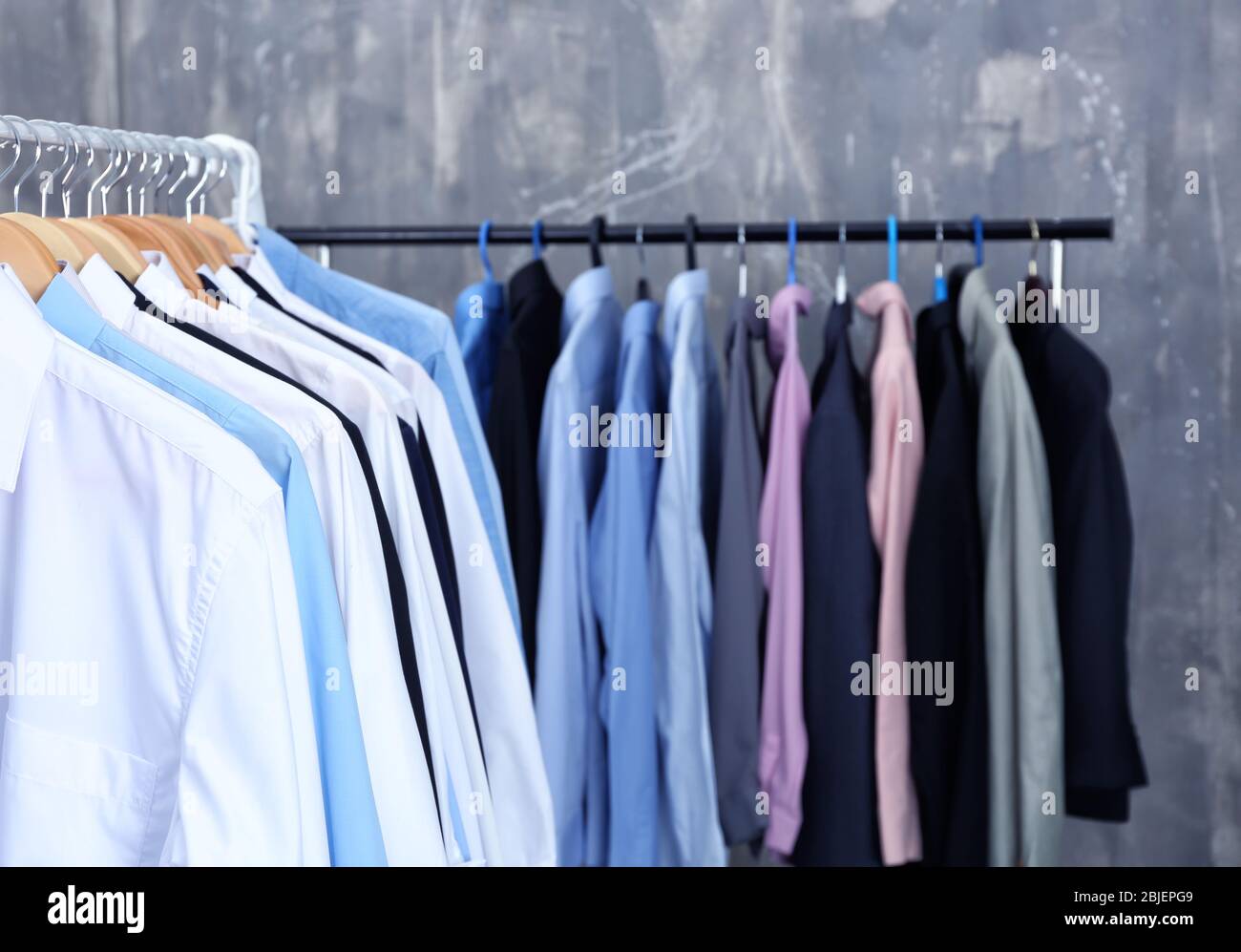 https://c8.alamy.com/comp/2BJEPG9/rack-of-clean-clothes-hanging-on-hangers-at-dry-cleaning-2BJEPG9.jpg