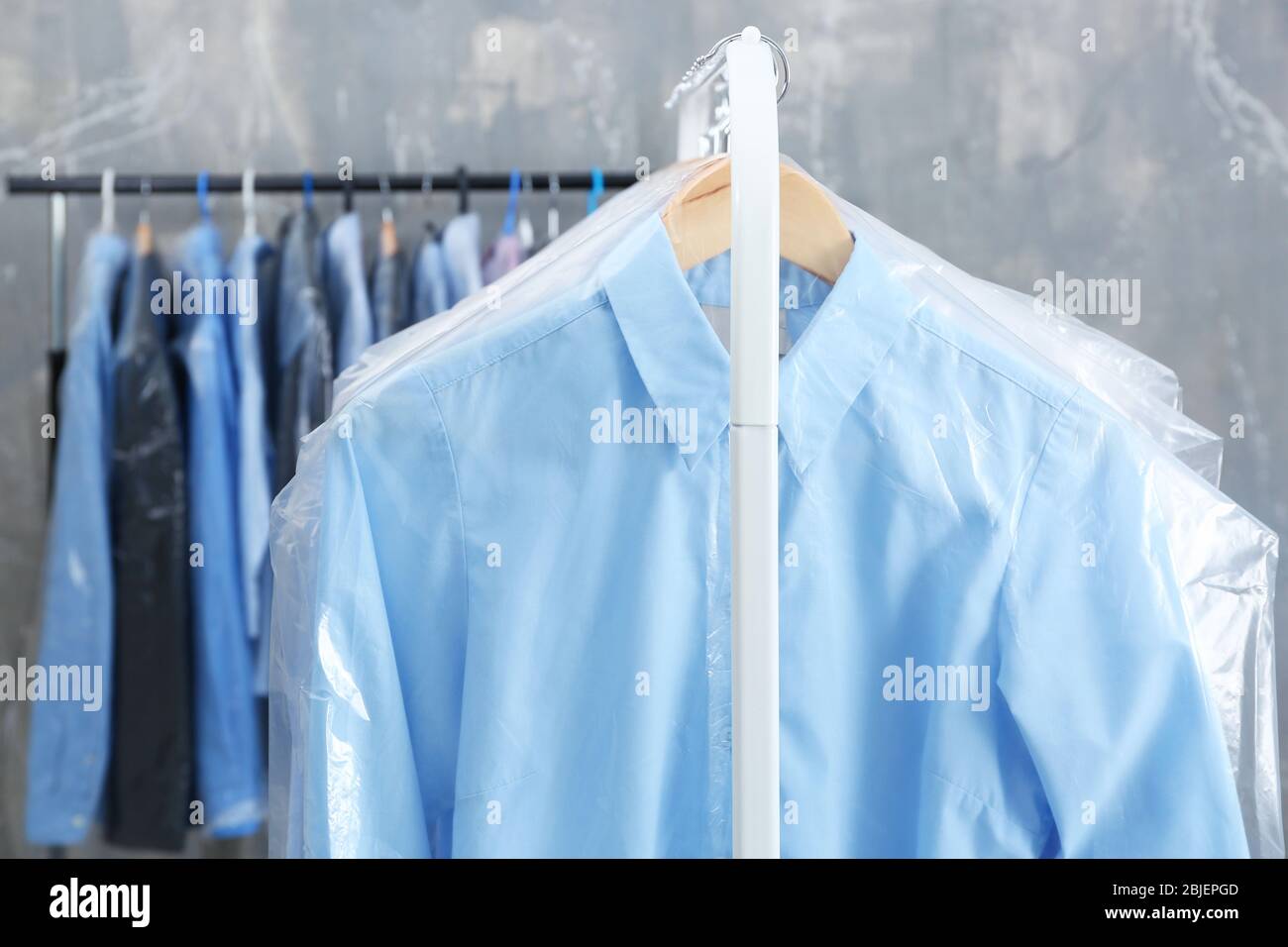 https://c8.alamy.com/comp/2BJEPGD/rack-of-clean-clothes-hanging-on-hangers-at-dry-cleaning-2BJEPGD.jpg