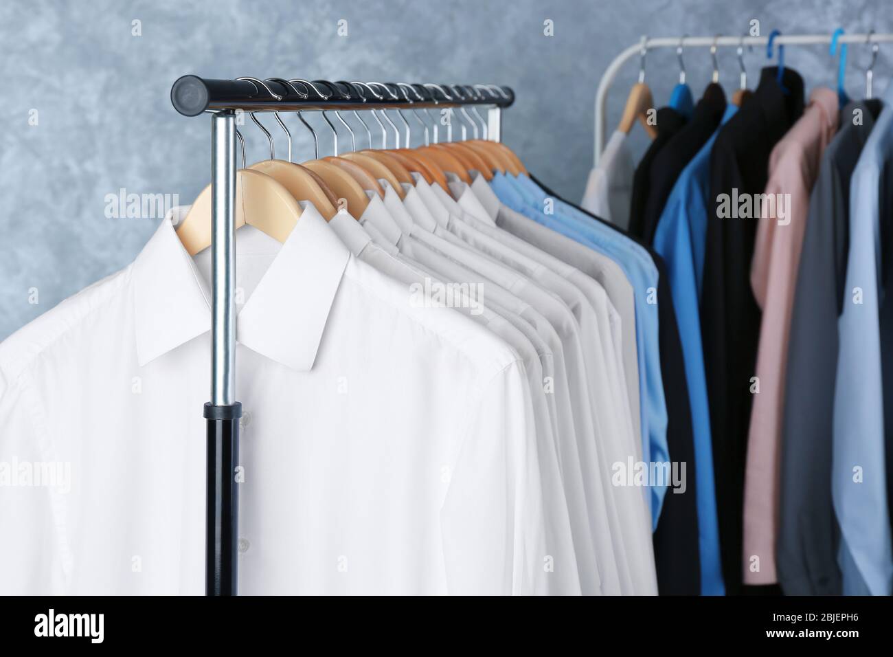 Rack of clean clothes hanging on hangers at drycleaning Stock Photo Alamy