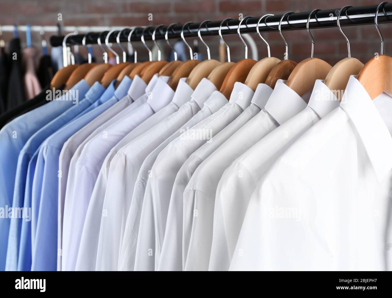 Rack of clean clothes hanging on hangers at dry-cleaning Stock Photo ...