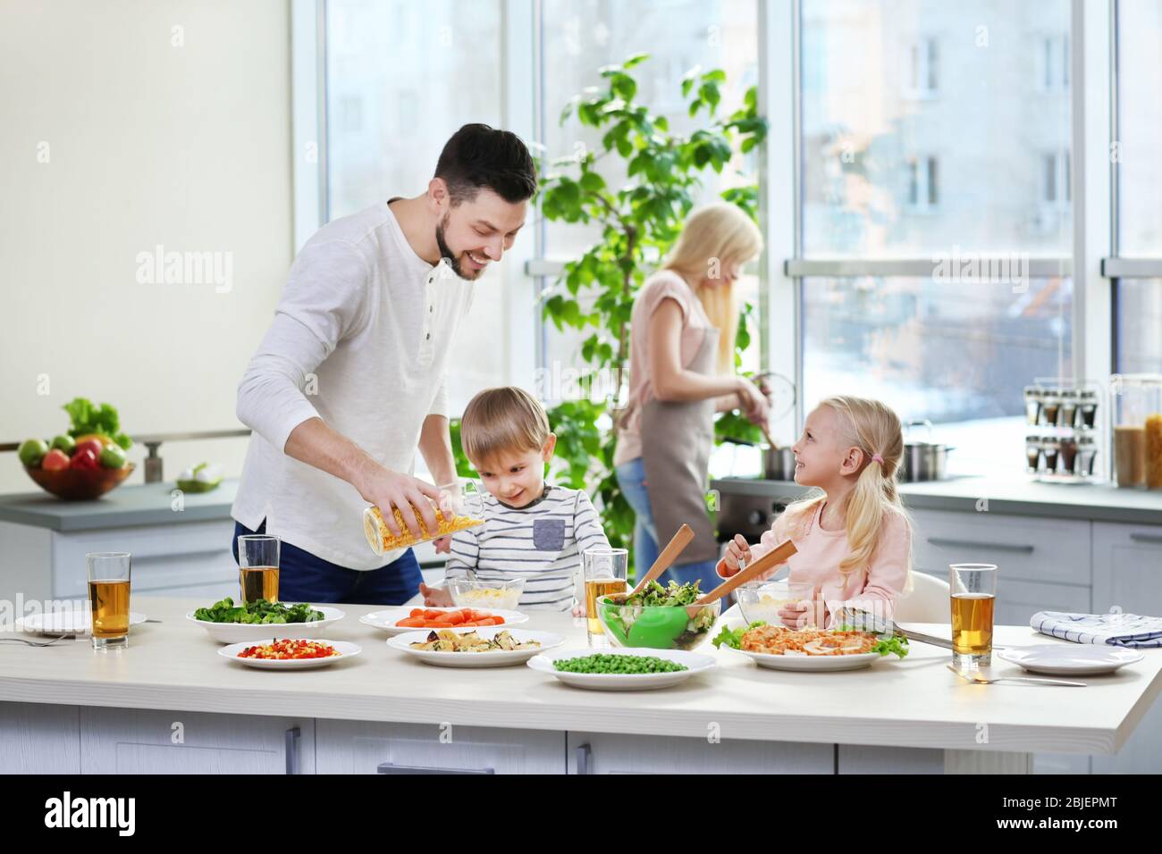 Happy family having breakfast at home Stock Photo - Alamy