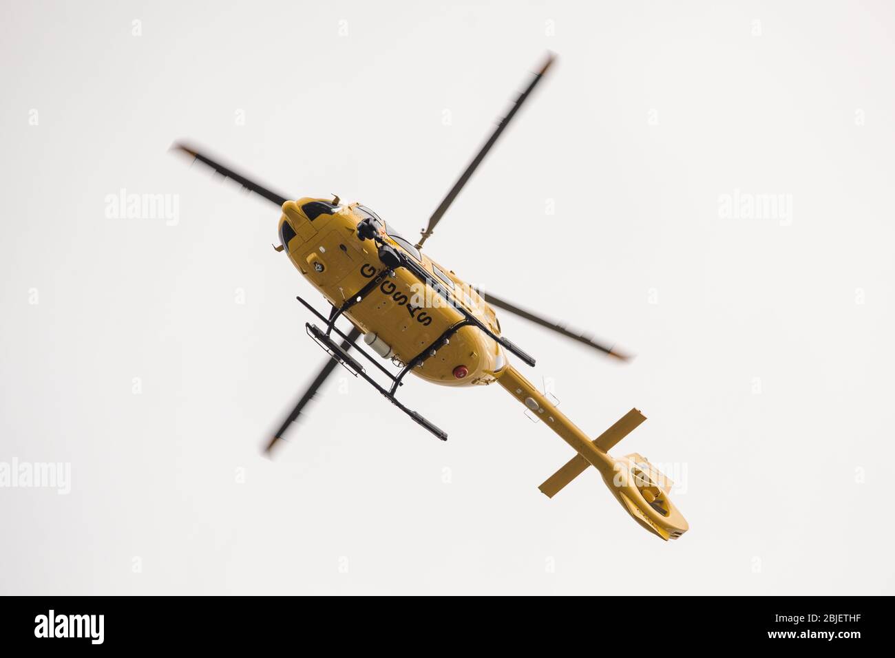 Glasgow, UK. 28 April 2020.   Pictured: Scottish Air Ambulance Service helicopter (Airbus Helicopter H145 / EC145T2) seen about to land at the Queen Elizabeth University Hospital transferring more Covid-19 patients. Credit: Colin Fisher/Alamy Live News. Stock Photo