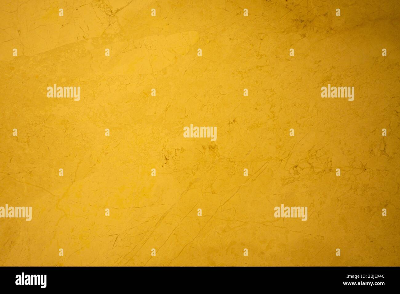 Golden yellow stone marble surface backdrop Stock Photo