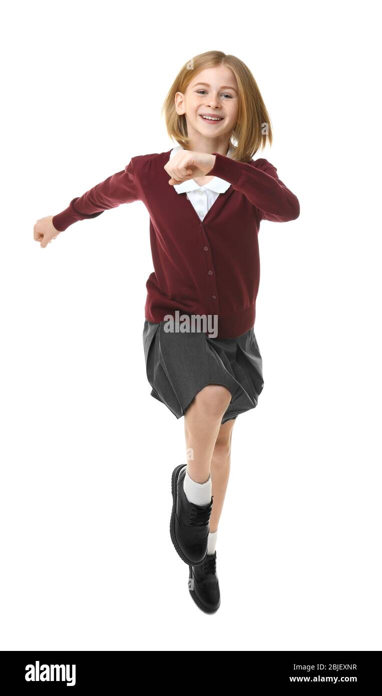 Cute girl in school uniform running on white background Stock Photo Alamy
