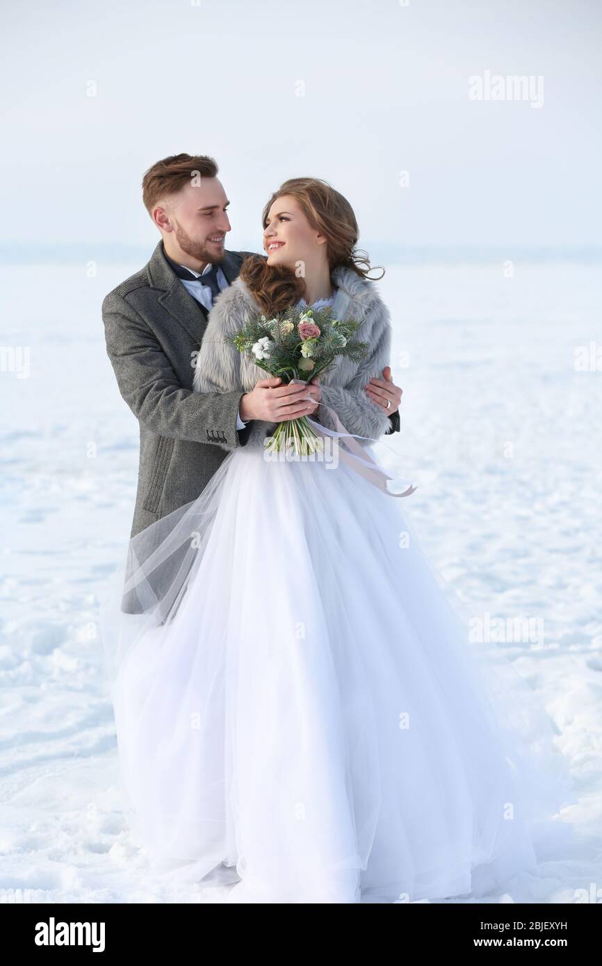 Happy wedding couple outdoors on winter day Stock Photo - Alamy