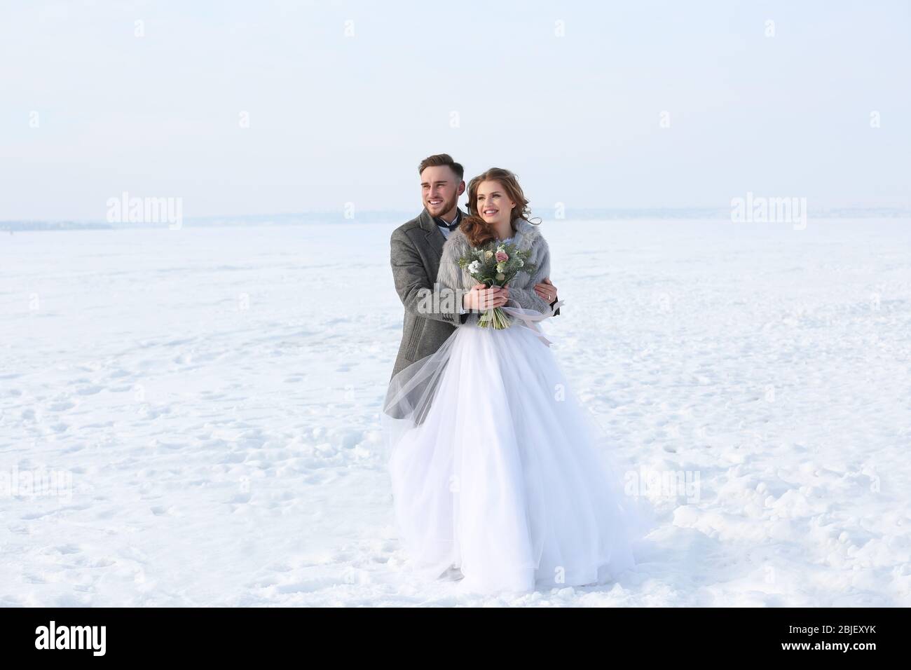 Happy wedding couple outdoors on winter day Stock Photo - Alamy