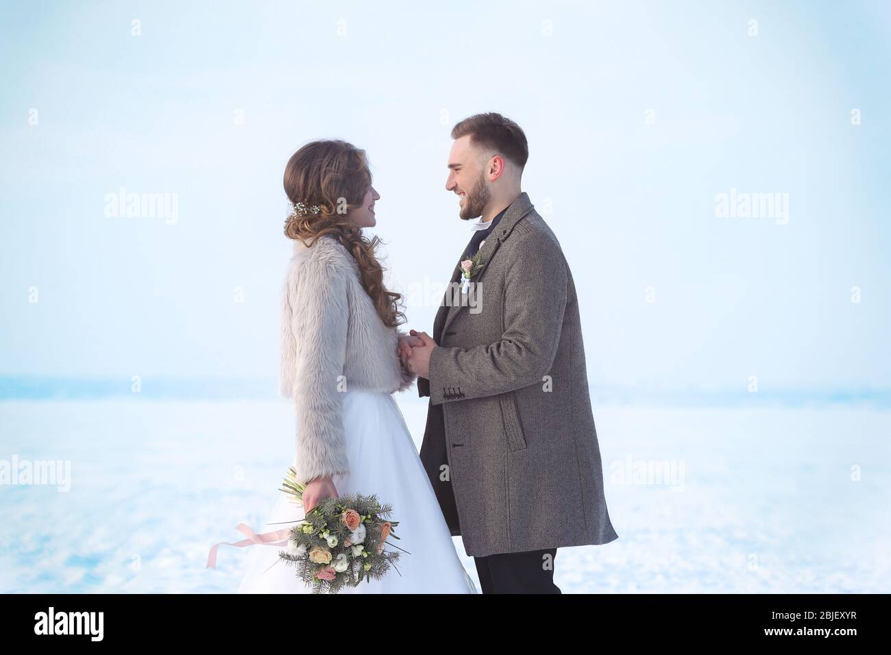 Happy wedding couple outdoors on winter day Stock Photo - Alamy