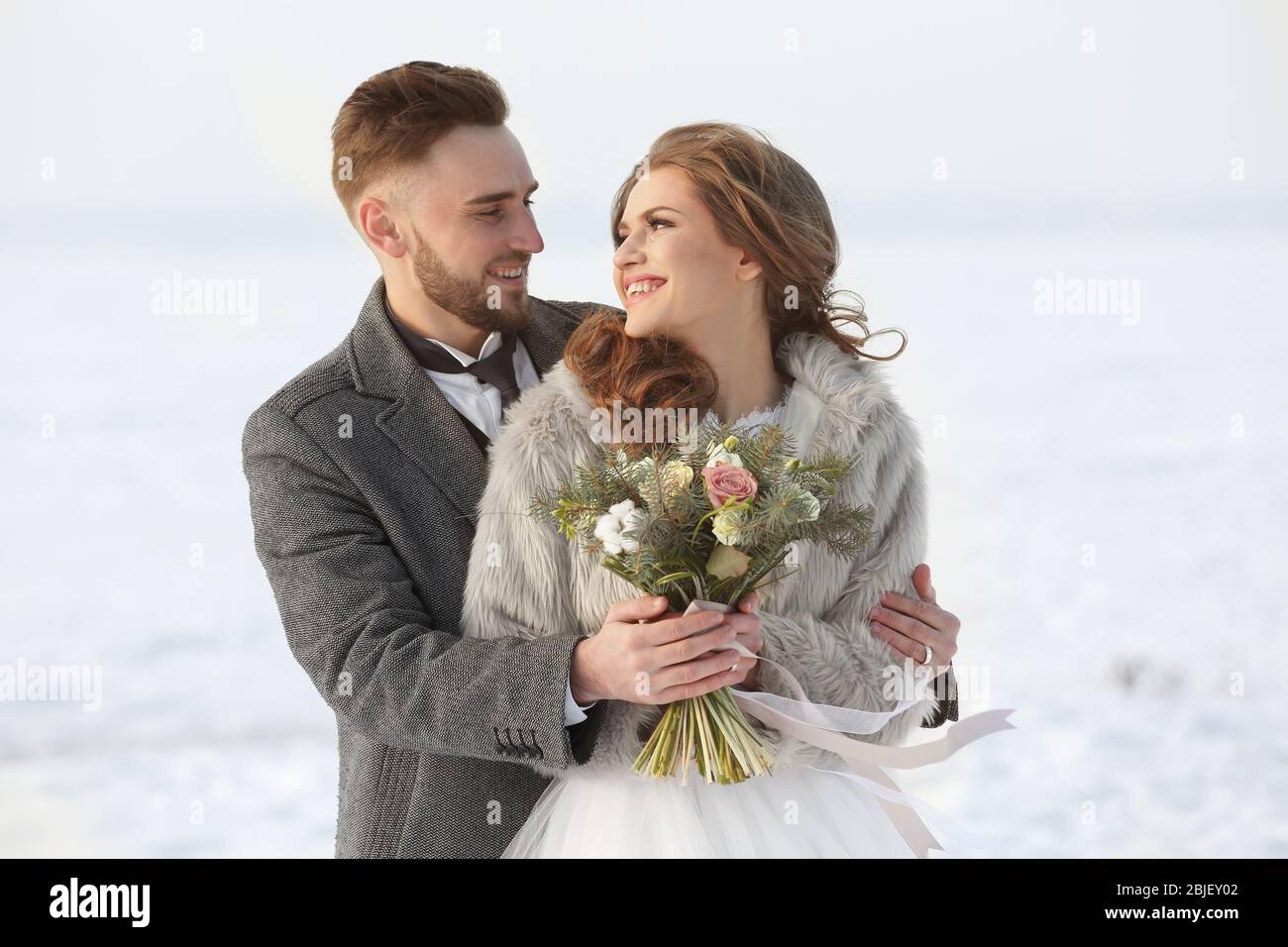 Happy wedding couple outdoors on winter day Stock Photo - Alamy