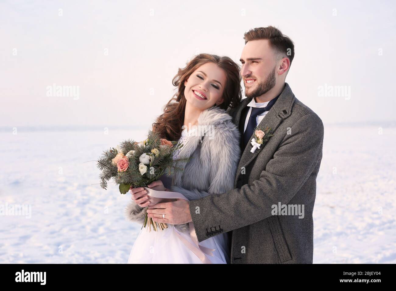 Happy wedding couple outdoors on winter day Stock Photo - Alamy