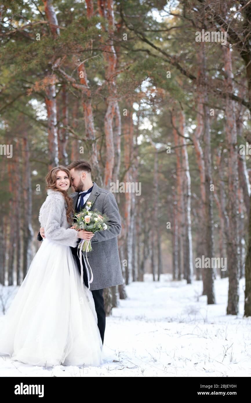 Happy wedding couple outdoors on winter day Stock Photo - Alamy