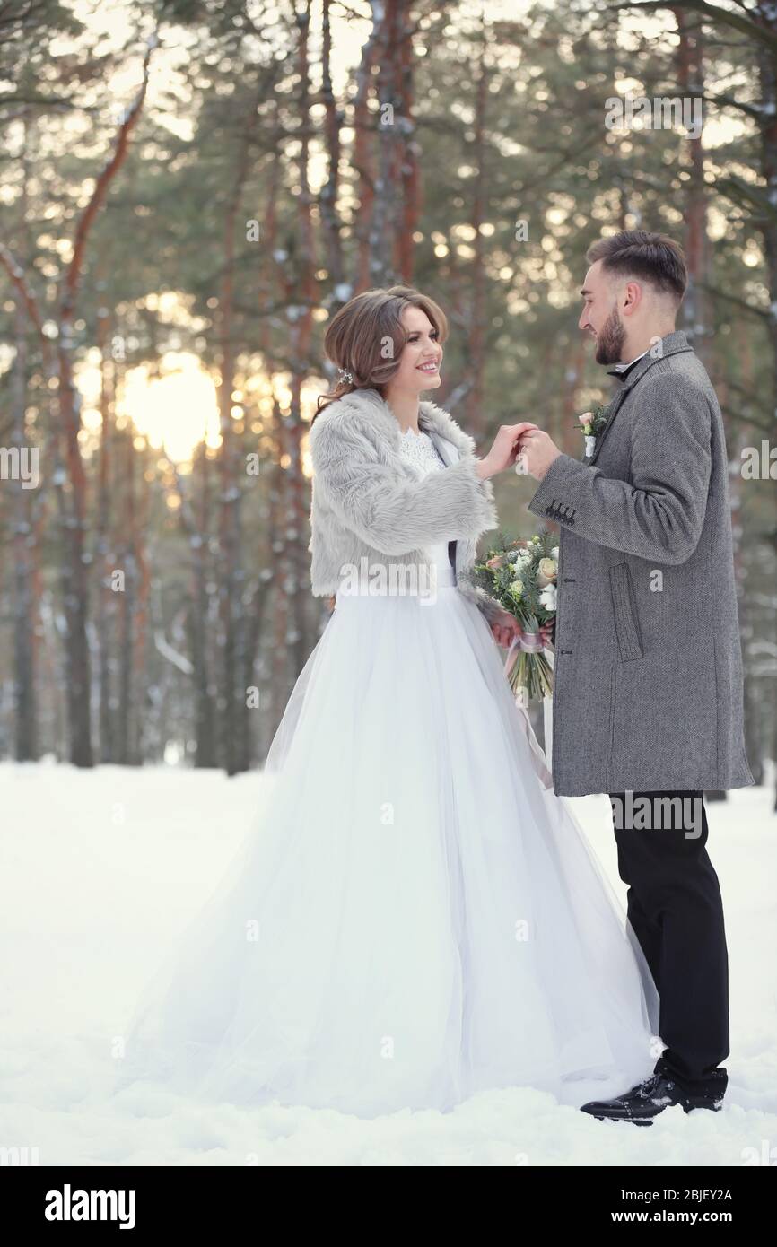 Happy wedding couple outdoors on winter day Stock Photo - Alamy
