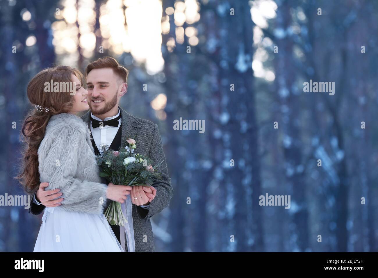 Happy wedding couple outdoors on winter day Stock Photo - Alamy