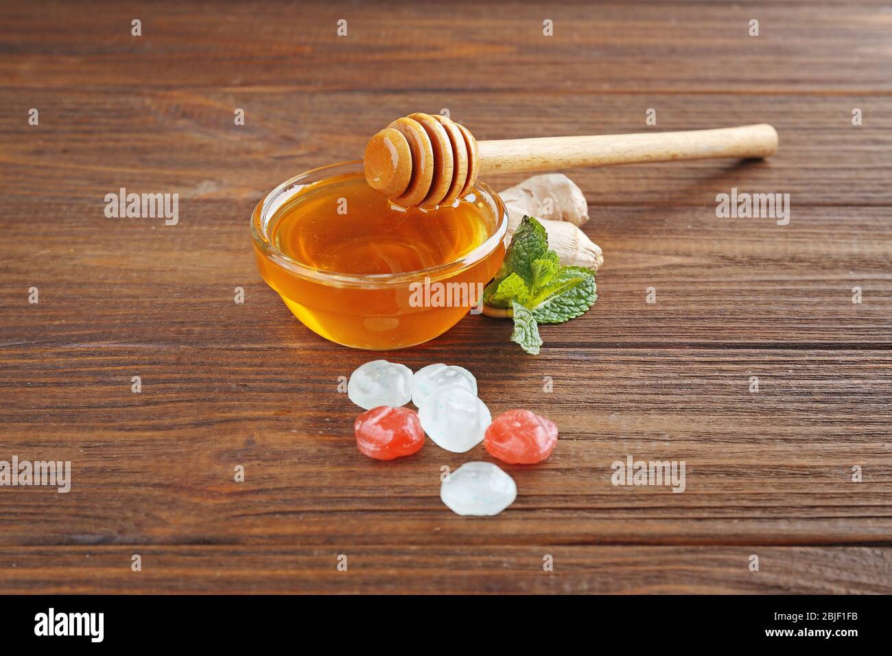 Cough drops with honey on wooden background Stock Photo